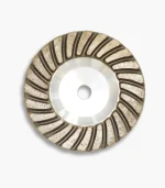 Front view of a 100mm aluminium diamond cup wheel, showing the aggressive segmented rim used for grinding refractory materials.
